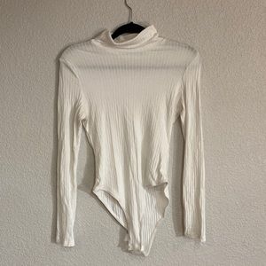 White turtleneck bodysuit.
